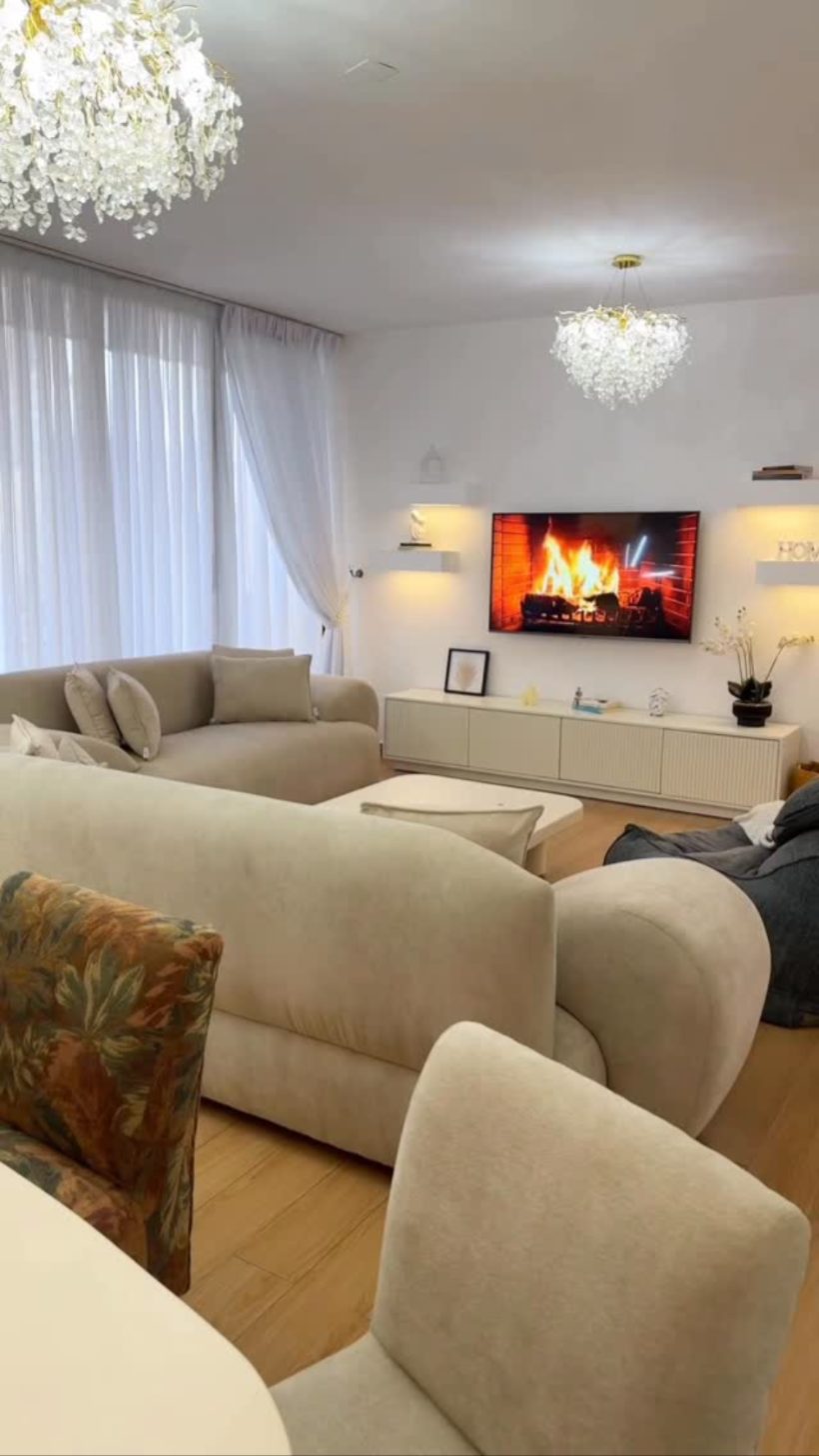 Bright living room with curved cream modular sectional